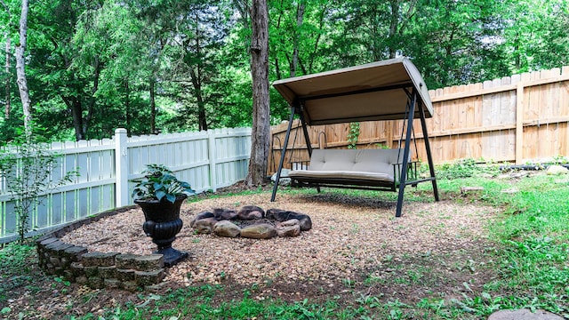 fenced backyard featuring a carport