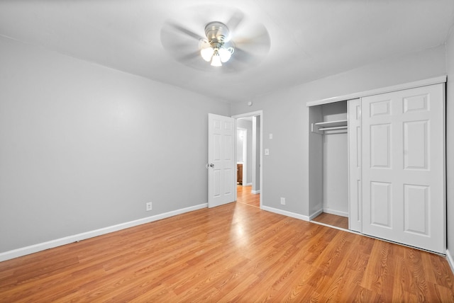 unfurnished bedroom with light wood-style floors, baseboards, a closet, and ceiling fan
