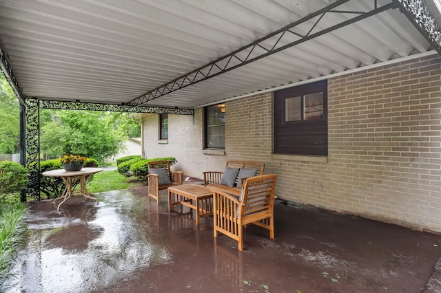view of patio / terrace with an attached carport and an outdoor living space