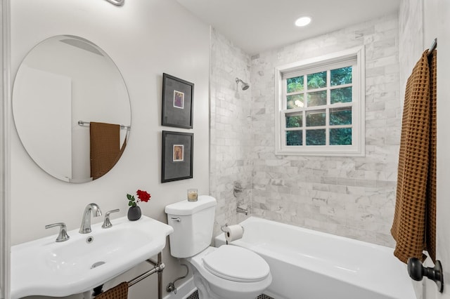 full bath featuring a sink, toilet, and washtub / shower combination