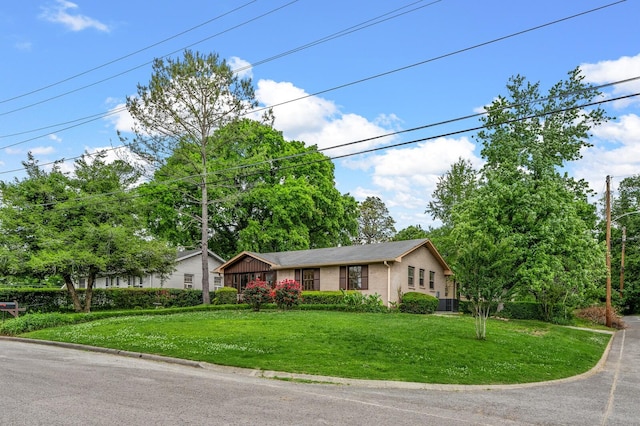 ranch-style home featuring a front yard and brick siding