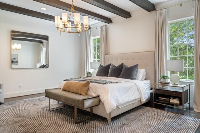 bedroom featuring a chandelier, multiple windows, beam ceiling, and wood finished floors