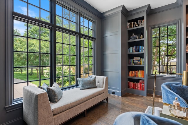 sitting room featuring dark wood-style floors and ornamental molding