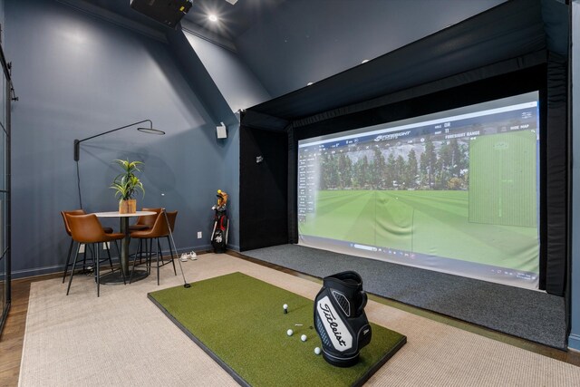 playroom featuring golf simulator and baseboards