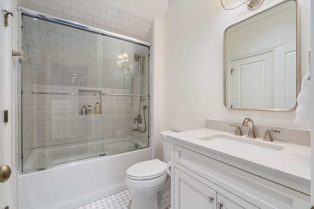 bathroom with combined bath / shower with glass door, toilet, and vanity