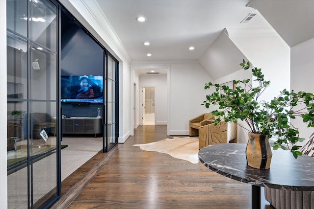 hall featuring wood finished floors, recessed lighting, baseboards, and ornamental molding