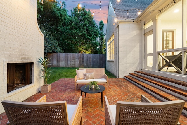 view of patio / terrace featuring entry steps and an outdoor living space with a fireplace