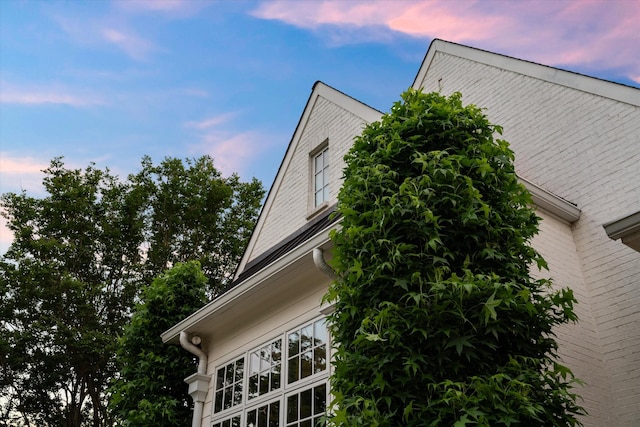 view of side of home featuring brick siding