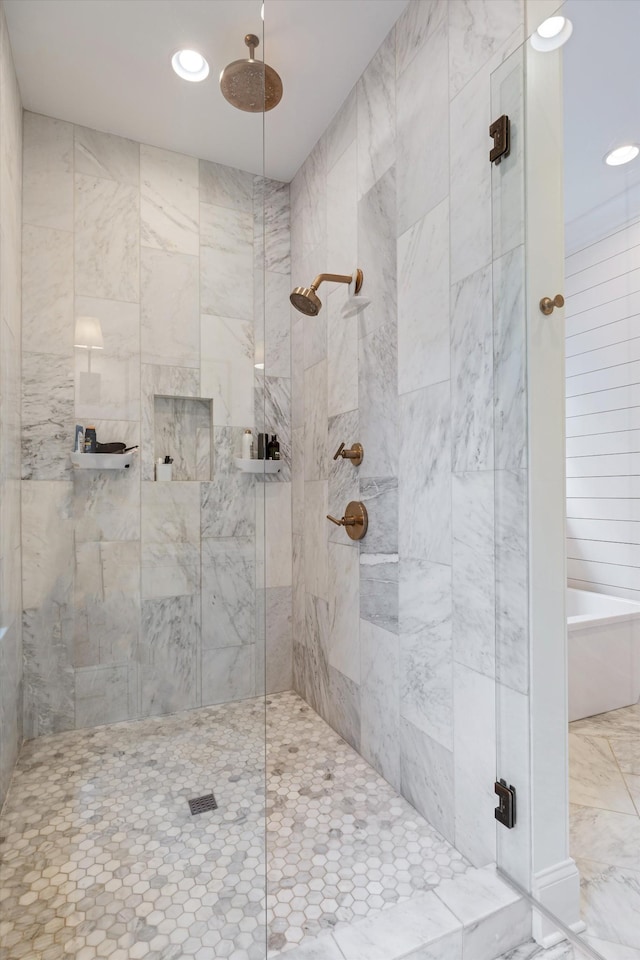 bathroom with a tile shower and recessed lighting