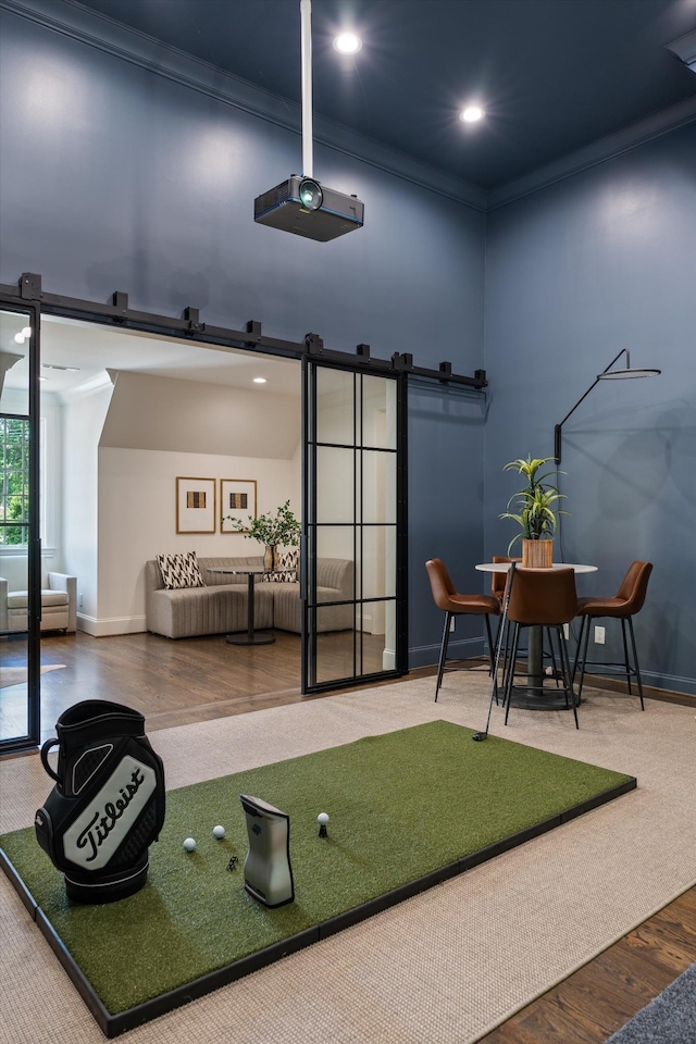 rec room featuring recessed lighting, baseboards, wood finished floors, and crown molding