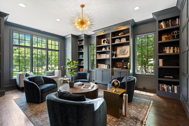 living area with crown molding, recessed lighting, dark wood-type flooring, a chandelier, and baseboards