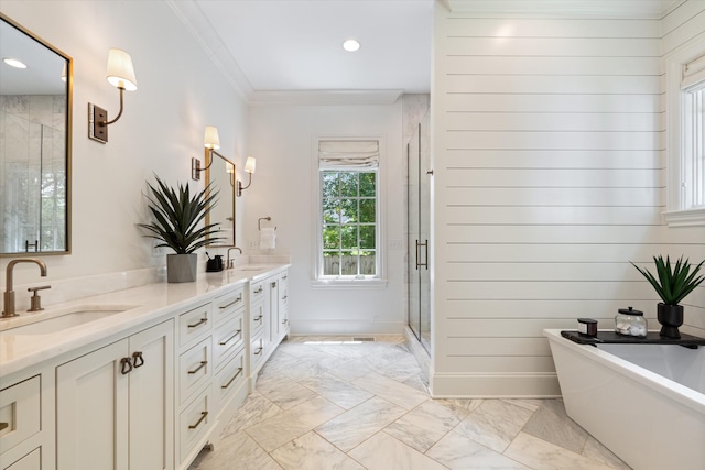 bathroom with marble finish floors, a shower stall, double vanity, a freestanding tub, and ornamental molding