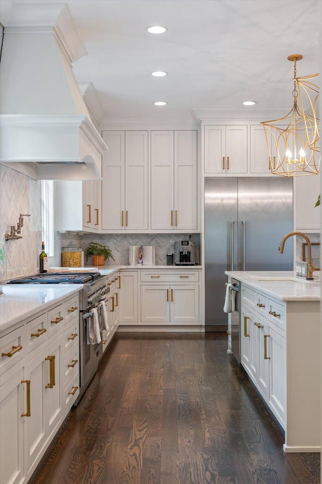 kitchen featuring custom exhaust hood, a sink, white cabinets, dark wood finished floors, and pendant lighting