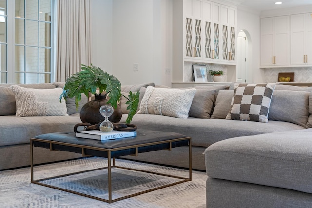 living room featuring arched walkways and recessed lighting