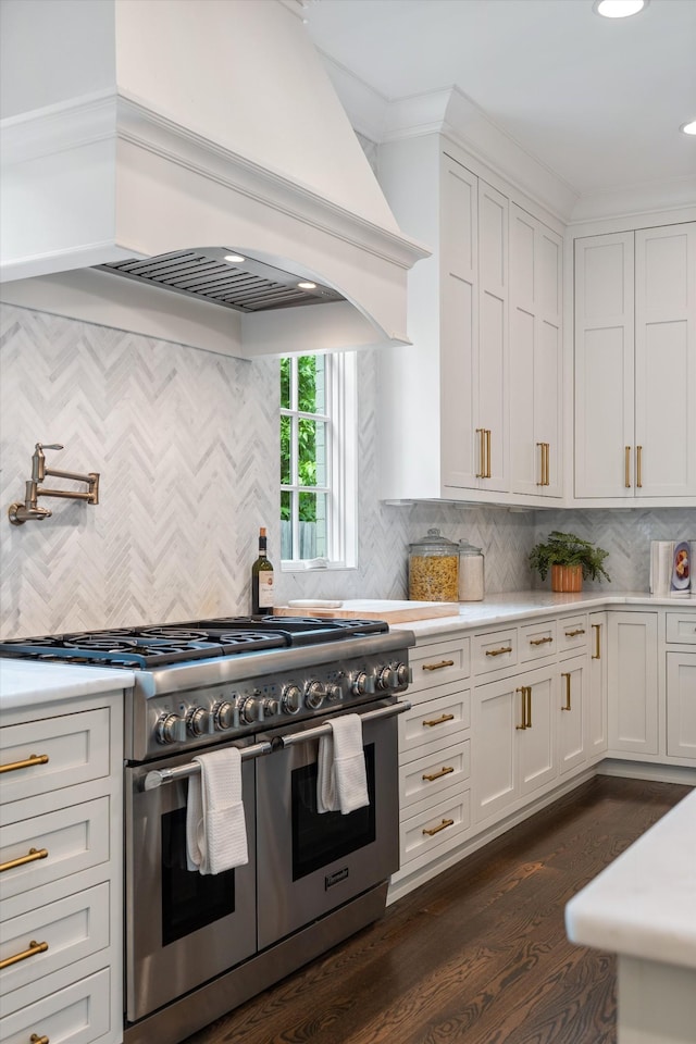 kitchen featuring double oven range, premium range hood, light countertops, backsplash, and recessed lighting