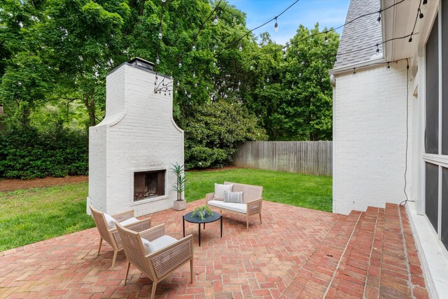 view of patio / terrace with an outdoor living space with a fireplace