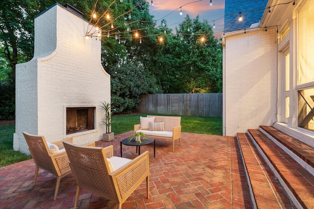 view of patio with an outdoor living space with a fireplace