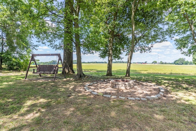 7547 Elm Springs Rd, Orlinda, TN 37141 - view of green lawn featuring a fire pit