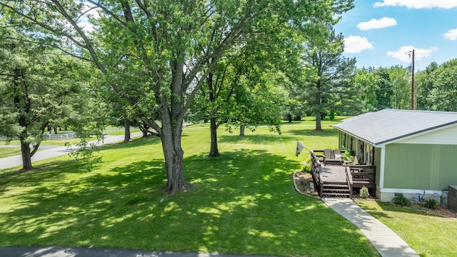 7547 Elm Springs Rd, Orlinda, TN 37141 - view of green lawn featuring a wooden deck and view of wooded area