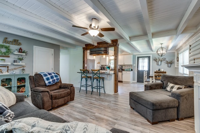 7547 Elm Springs Rd, Orlinda, TN 37141 - living room with a chandelier, light wood-style flooring, beam ceiling, a ceiling fan, and a fireplace