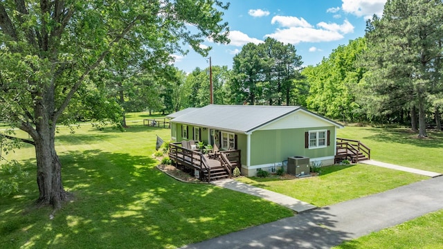 7547 Elm Springs Rd, Orlinda, TN 37141 - view of property exterior featuring a porch, a lawn, a metal roof, and view of scattered trees