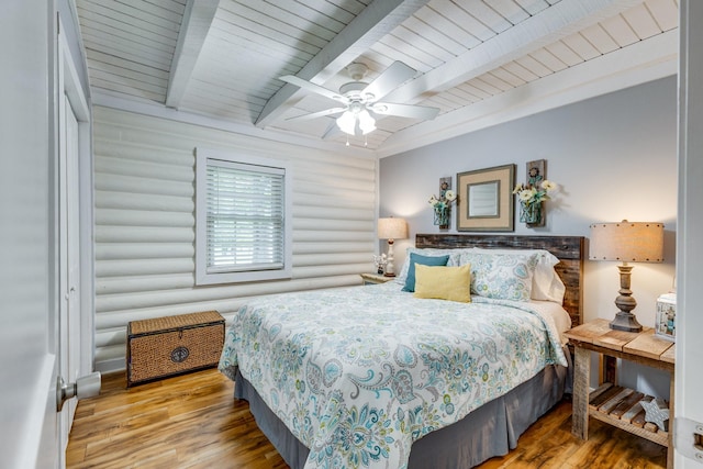 7547 Elm Springs Rd, Orlinda, TN 37141 - bedroom with wood finished floors, beamed ceiling, rustic walls, and a ceiling fan