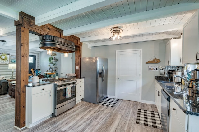 7547 Elm Springs Rd, Orlinda, TN 37141 - kitchen with stainless steel appliances, light wood-style floors, white cabinets, dark stone counters, and beamed ceiling