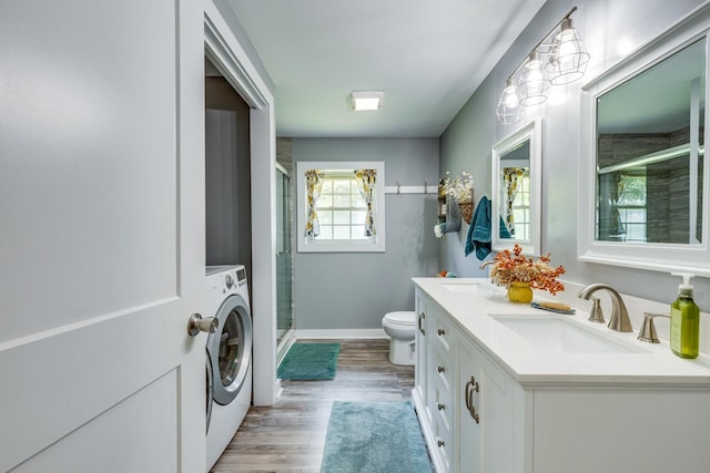 7547 Elm Springs Rd, Orlinda, TN 37141 - bathroom with washer / dryer, a shower stall, double vanity, and wood finished floors