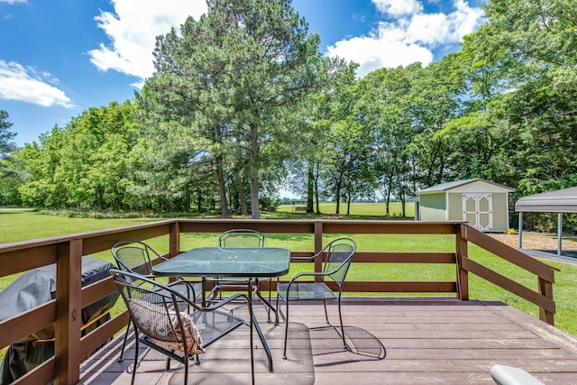 7547 Elm Springs Rd, Orlinda, TN 37141 - wooden terrace featuring a storage unit, a lawn, outdoor dining space, and view of wooded area