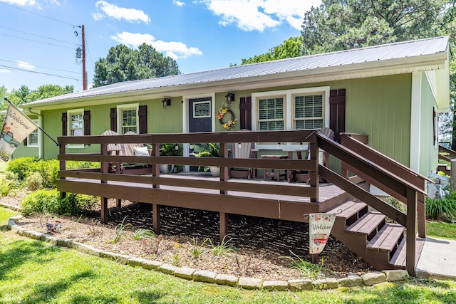 7547 Elm Springs Rd, Orlinda, TN 37141 - view of front of home with a wooden deck and a metal roof