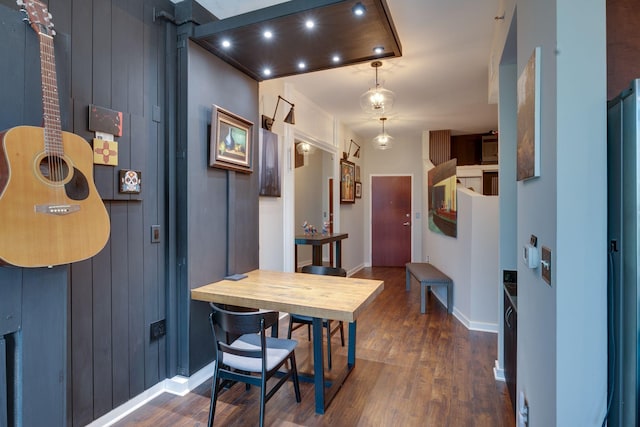 foyer with dark wood-style flooring and baseboards