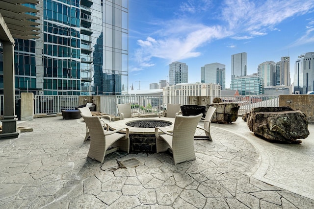 view of patio with a skyline view and an outdoor fire pit