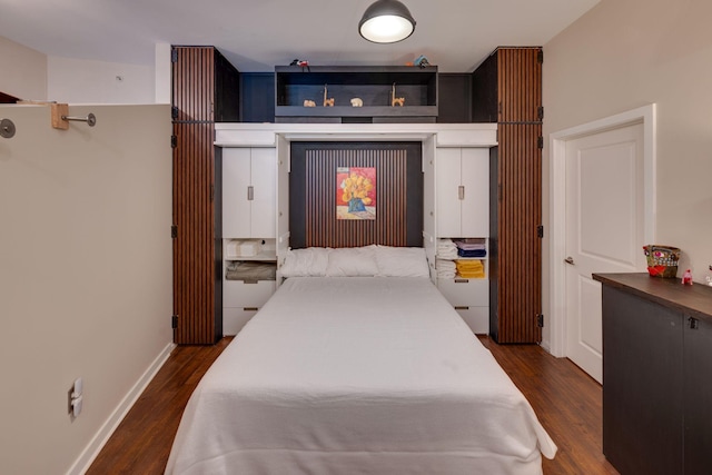 bedroom featuring dark wood-style flooring and baseboards
