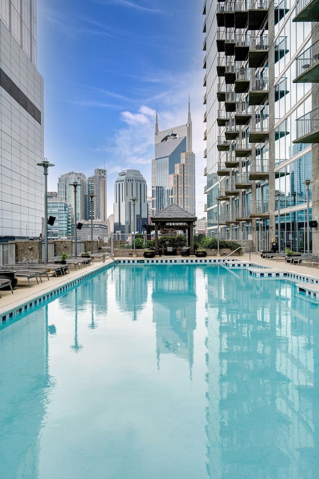 community pool with a view of skyline and a gazebo