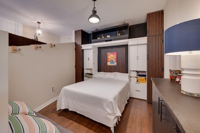 bedroom featuring dark wood-style floors and baseboards