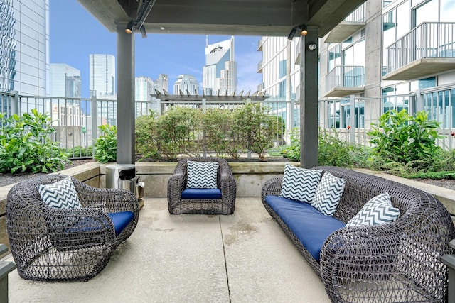 view of patio featuring a view of skyline and fence