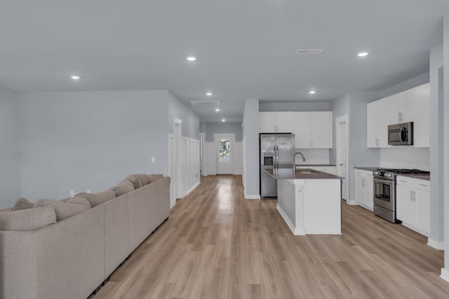 118 Merion Way, Lebanon, TN 37087 - kitchen with stainless steel appliances, open floor plan, light wood-style flooring, dark countertops, and recessed lighting
