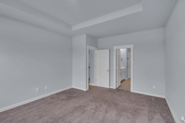 118 Merion Way, Lebanon, TN 37087 - unfurnished bedroom featuring carpet floors, baseboards, connected bathroom, and a tray ceiling