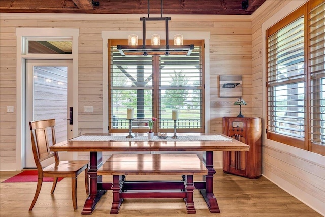 1165 River Bluffs Dr Unit Rb-97, Jasper, TN 37347 - dining space featuring wood walls, a chandelier, healthy amount of natural light, and light wood-style flooring
