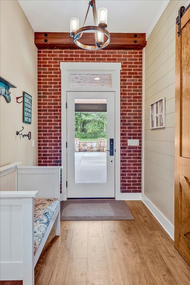 1165 River Bluffs Dr Unit Rb-97, Jasper, TN 37347 - entryway with a chandelier, light wood-style floors, a barn door, baseboards, and brick wall
