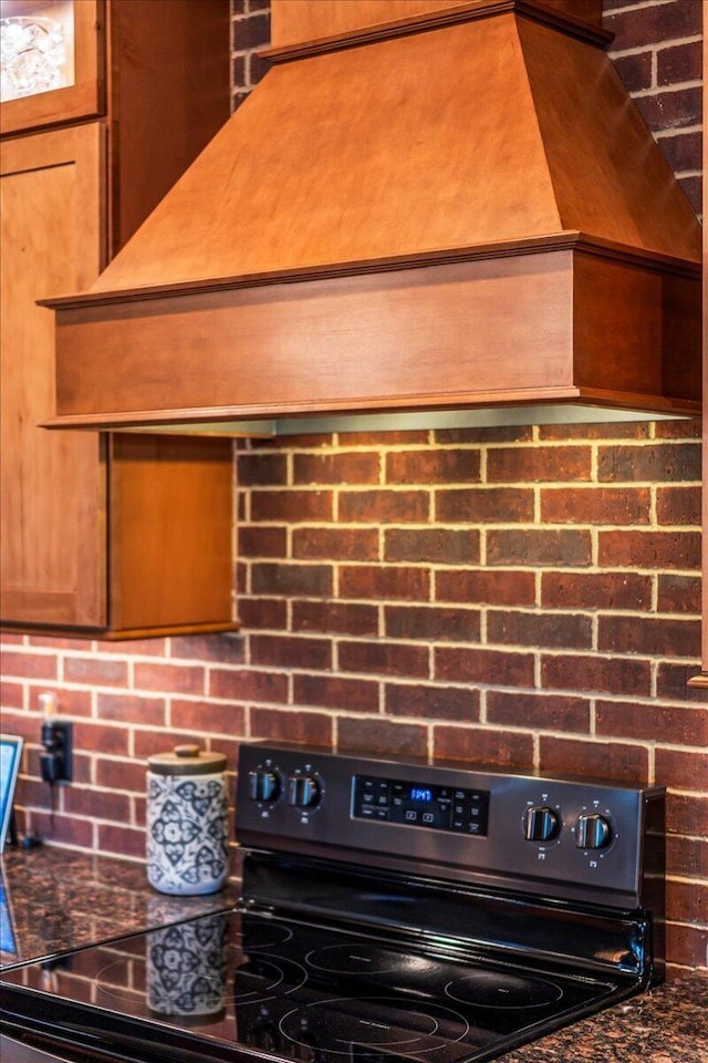 1165 River Bluffs Dr Unit Rb-97, Jasper, TN 37347 - kitchen view of black range with electric cooktop, decorative backsplash, dark countertops, and brown cabinets