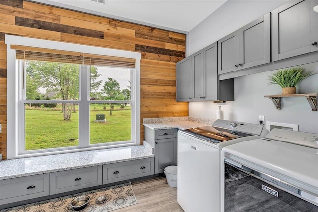 1165 River Bluffs Dr Unit Rb-97, Jasper, TN 37347 - clothes washing area featuring wooden walls, washing machine and dryer, healthy amount of natural light, and cabinet space
