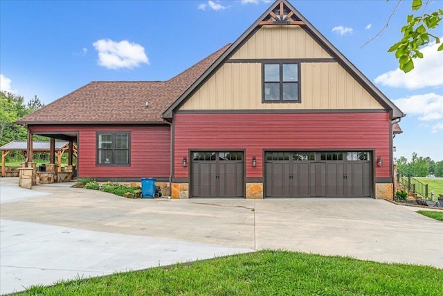 1165 River Bluffs Dr Unit Rb-97, Jasper, TN 37347 - view of front of house with driveway, an attached garage, roof with shingles, stone siding, and board and batten siding