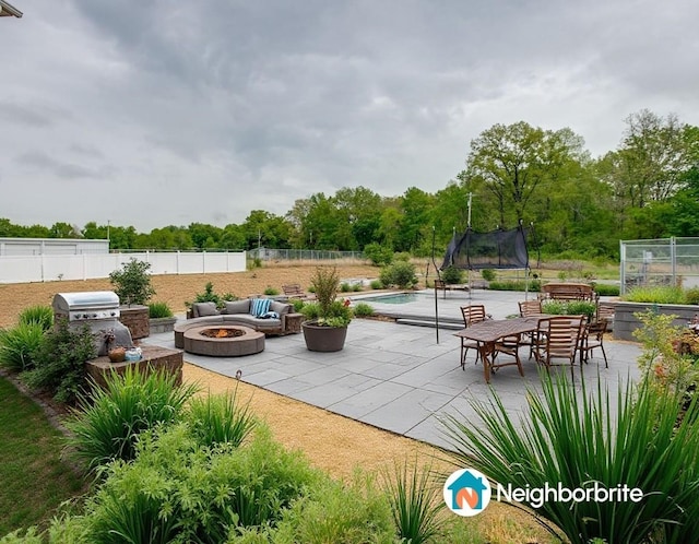 1017 Village Ct, Burns, TN 37029 - view of patio with an outdoor fire pit, a trampoline, fence, and an outdoor pool