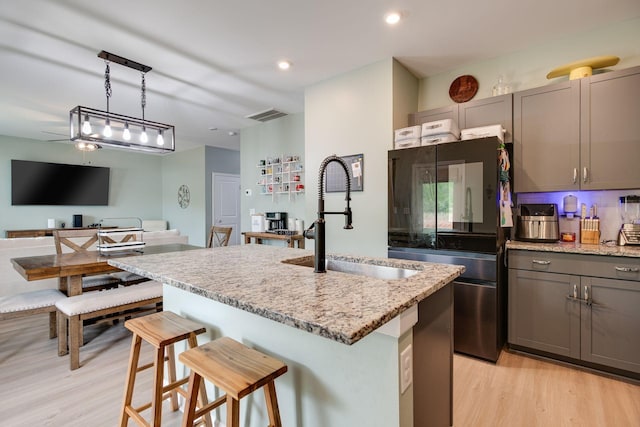 1017 Village Ct, Burns, TN 37029 - kitchen with a sink, smart refrigerator, light wood finished floors, light stone counters, and gray cabinetry