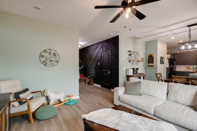 1017 Village Ct, Burns, TN 37029 - living room featuring light wood-style floors, a ceiling fan, baseboards, and recessed lighting