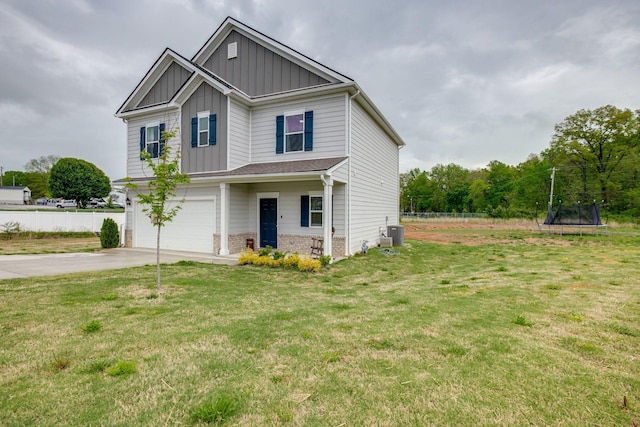 1017 Village Ct, Burns, TN 37029 - craftsman-style house featuring board and batten siding, a trampoline, an attached garage, driveway, and brick siding