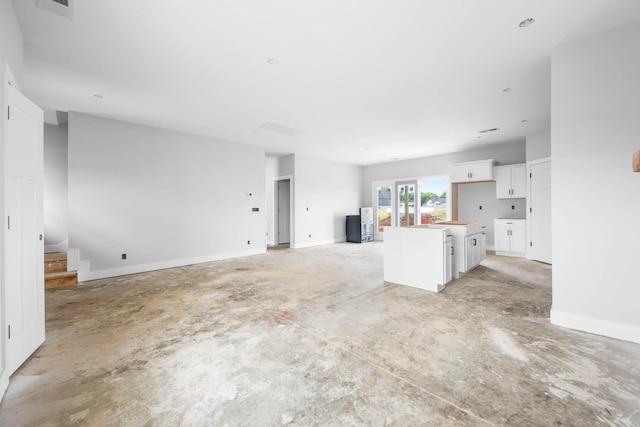 961 Isaac Dr, Clarksville, TN 37040 - unfurnished living room featuring concrete flooring, stairway, and baseboards