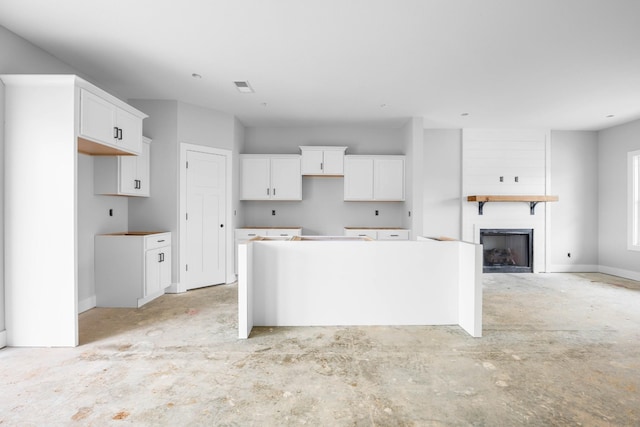 961 Isaac Dr, Clarksville, TN 37040 - kitchen featuring a center island, white cabinetry, and a large fireplace