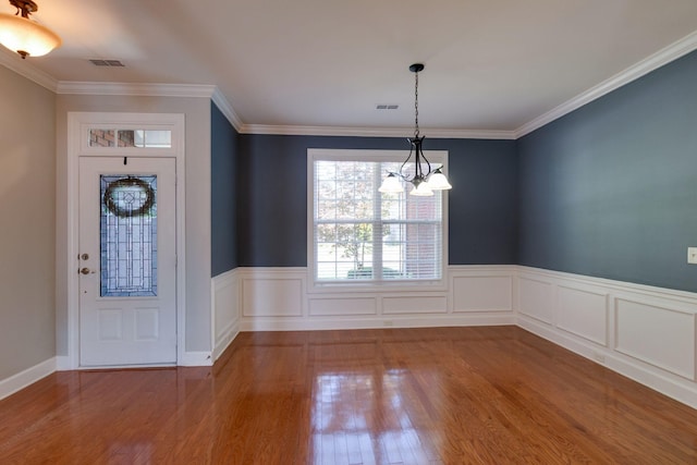 3024 Brookside Path, Murfreesboro, TN 37128 - foyer entrance featuring a chandelier, wood finished floors, a wainscoted wall, and ornamental molding